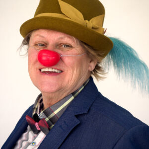 Clown souriant avec nez rouge et chapeau détail.